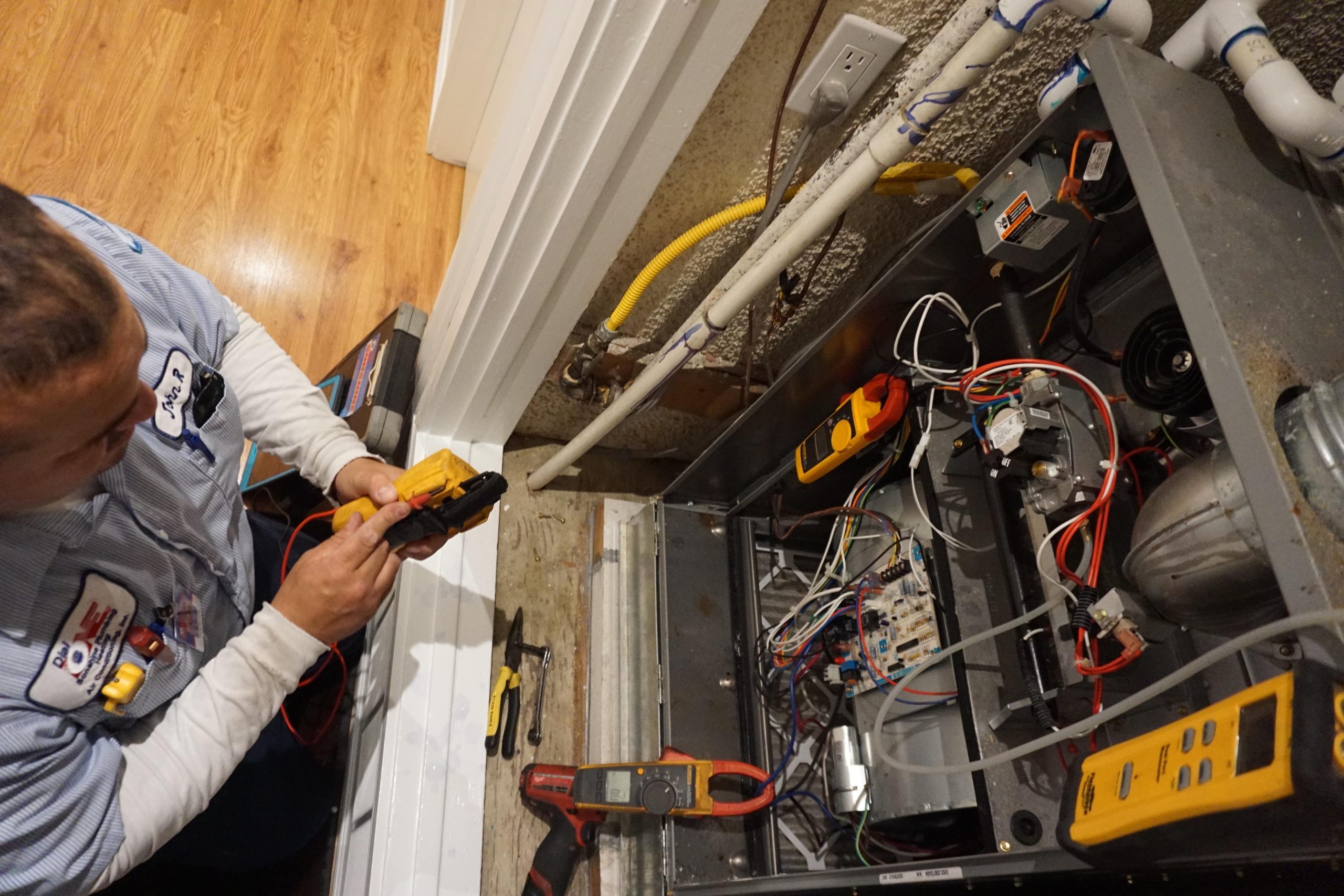 A technician inspecting a furnace