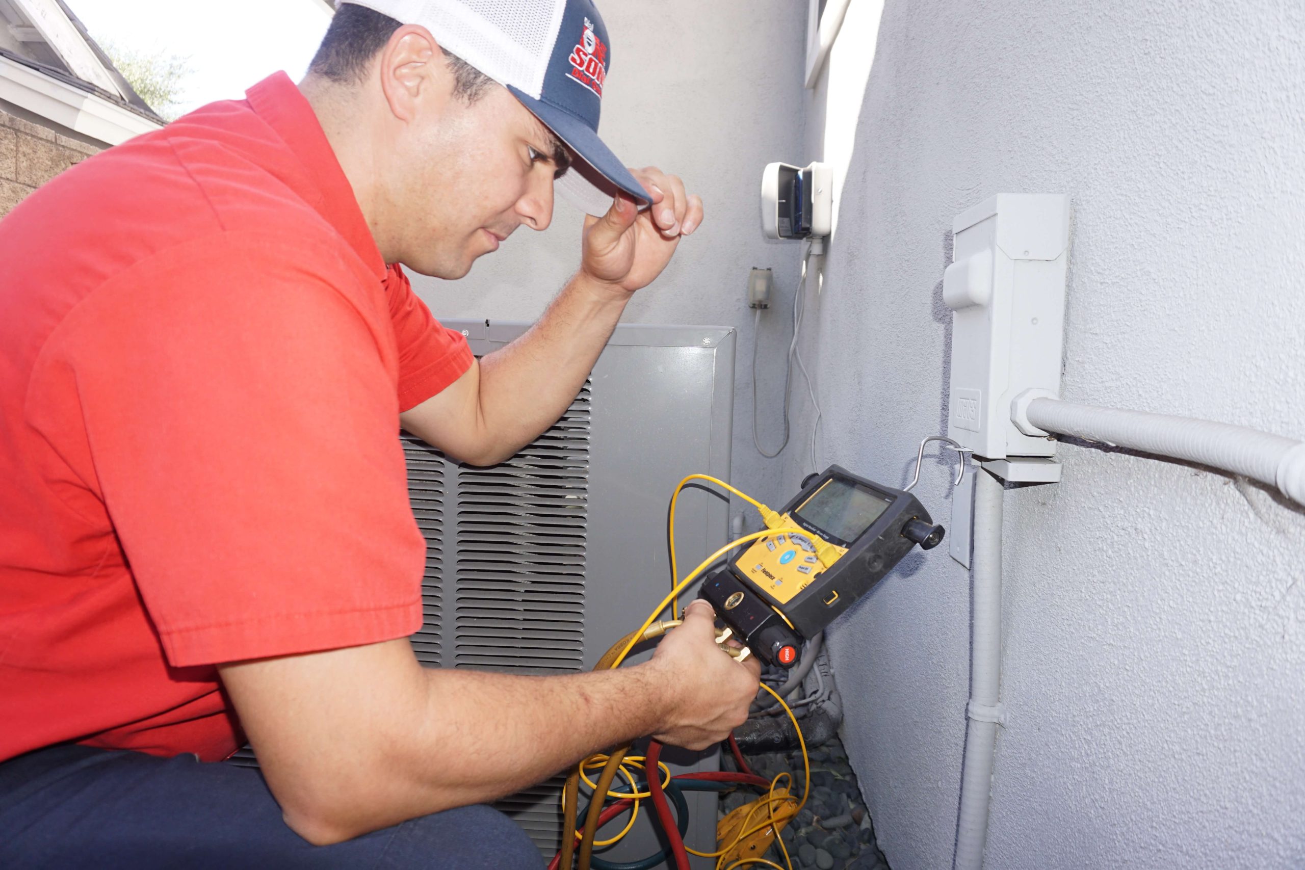 A technician checking refrigerant levels